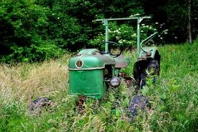 old green tractor among the colorful nature