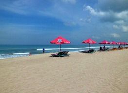 deck chairs under umbrellas on the beach in bali