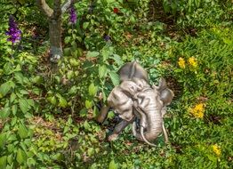 Golden elephant statue sculpture in green garden