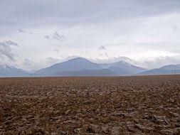 beyond the field are mountains