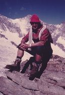 mountain guide on a stone in the alps