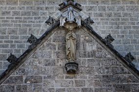 sculpture of the Madonna on the stone wall of the church