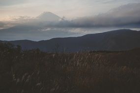 mountain under the clouds at dusk