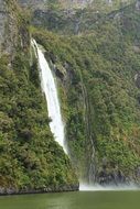 waterfall on green rock