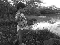 child by lake landscape