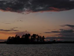 island on saimaa lake at dusk, finland