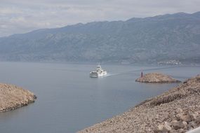 ferry sailing along the mountains in Croatia
