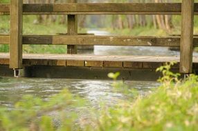 wooden bridge near the water in the village