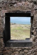 ocean coast through the fortress window