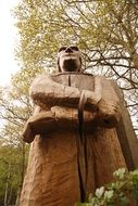wooden statue of a woodsman in the forest, bottom view