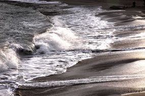 white foam waves on the beach