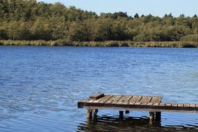 wooden pier on a lake in a nature park, germany, niederrhein