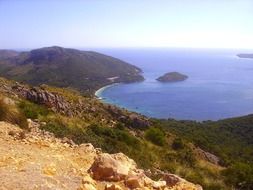 blue bay beneath mountain