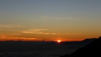 sunrise above dark horizon, indonesia