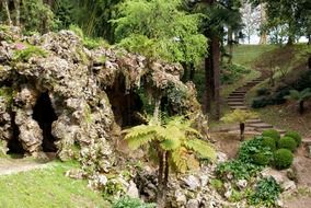 landscaped garden with artificial rock and pond at spring