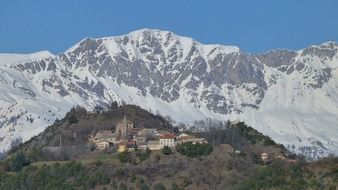 remote view of a mountain village in the alps on a sunny day