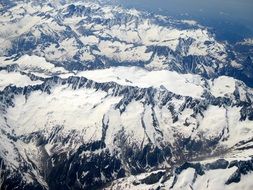 birds eye view of alpine mountains in snow