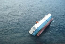 aerial view of an inverted ship on the water