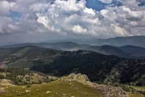 landscape of high hills with green grass on it