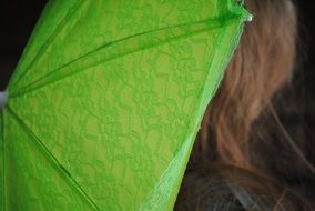 green umbrella behind the girl's back