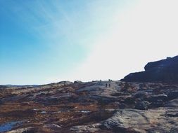 Picture of people are trekking on a rock