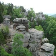 panoramic view of mountain formations among green trees