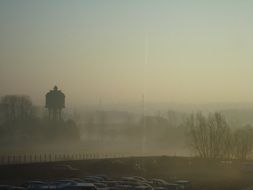 water tower in the fog in the morning