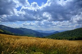Wonderful Clouds over green hills Yellow field