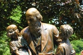 bronze monument to John Boll with kids