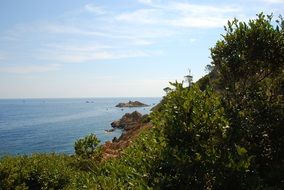 green cliff at blue sea