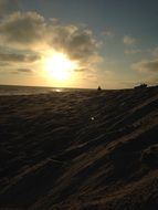 sunset over the beach in the dark