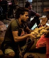 man near the potatoes in the market