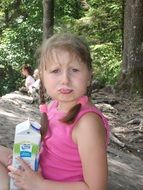 child with milk in forest