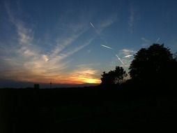 sky at sunset with contrails