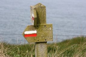 wooden direction sign on hiking trail