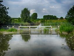 a pedestrian bridge on the background of the beautiful summer landscape