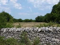 stone gray wall in a field in Muret