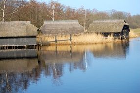 old wooden boat houses at water, autumn landscape, germany, prerow