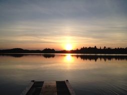 view from the pier to the sunset over the lake