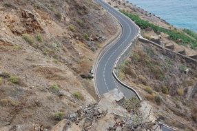 top view of winding road on mountain slope