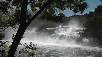 waterfall cascade in the sun rays