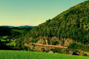 train on railroad at mountain side, beautiful rural landscape