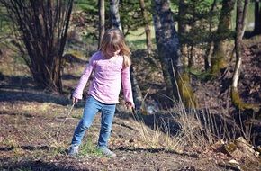 little girl in the spring forest