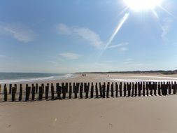 waterbreak on sand beach at sunny day