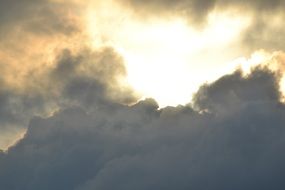 bright light on dark cloudy sky