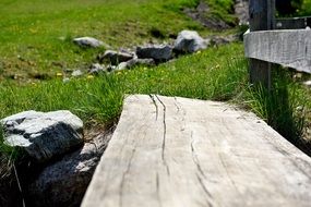 Wooden bench in green field