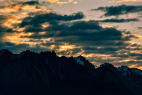 gloomy clouds over mountain peaks