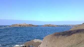 gray rocky coast and blue sea, france, brittany