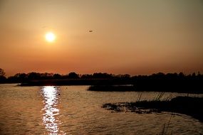 orange sun over the lake at sunset