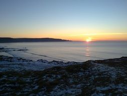 calm sunset above sea, view from coast